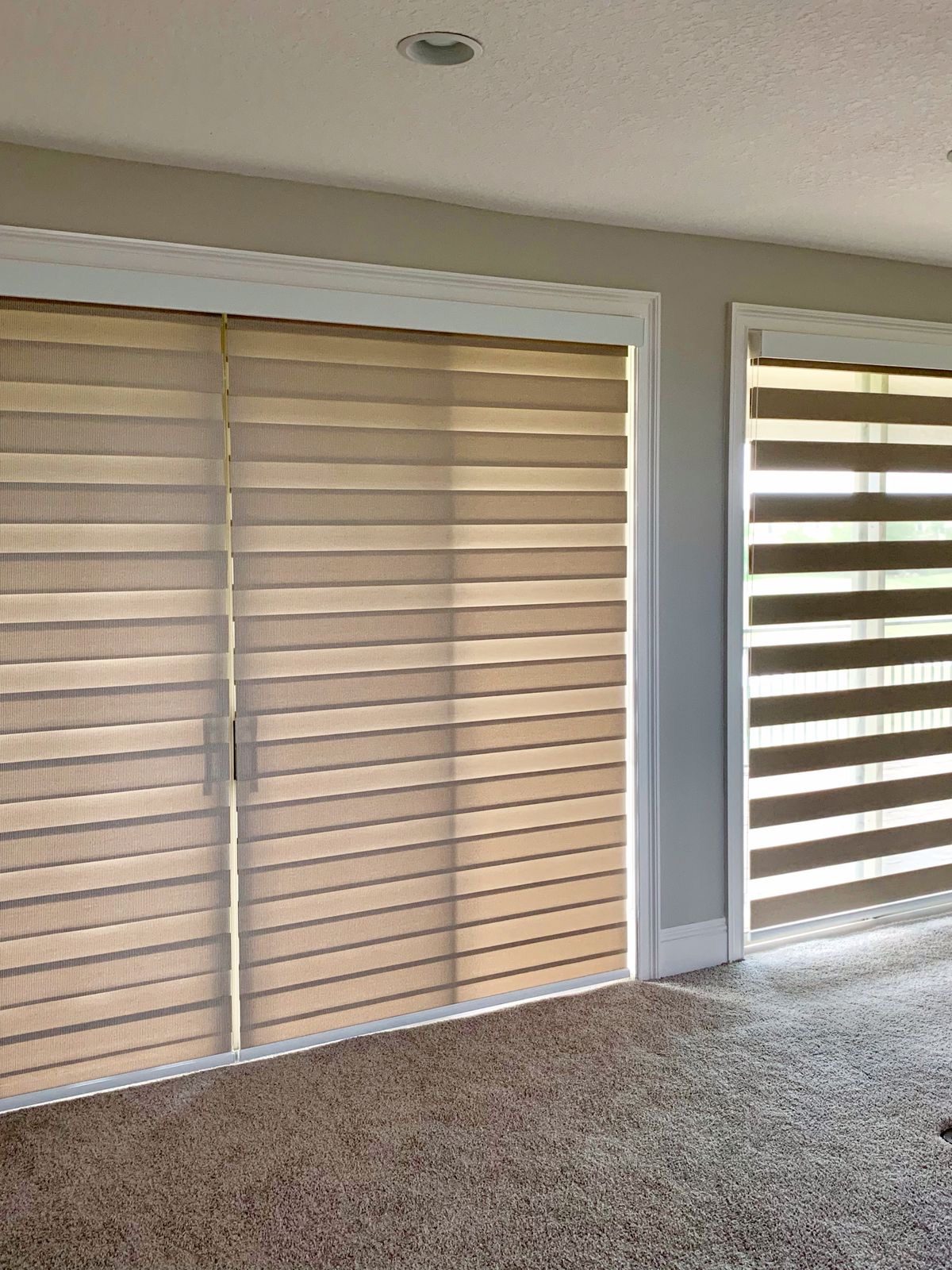Zebra blinds split over a sliding patio door, installed by SMI in Metro Vancouver